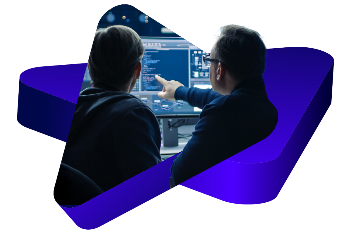 Image of two developers pointing at a screen and cropped by 3d triangle shapes