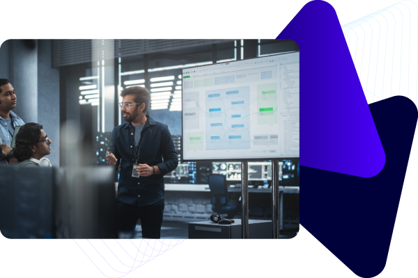 A group of professionals discussing in a high-tech conference room with large digital screens displaying data and charts.