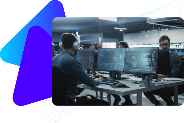 Two people working at desks with multiple computer monitors in a modern office.