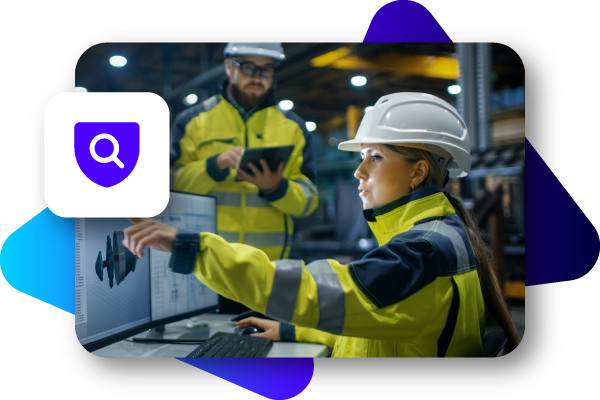 Two workers in safety gear examine a digital touch screen monitor in an industrial setting.