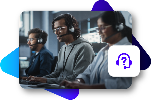 Three young men wearing headphones work on computers in a technology laboratory.