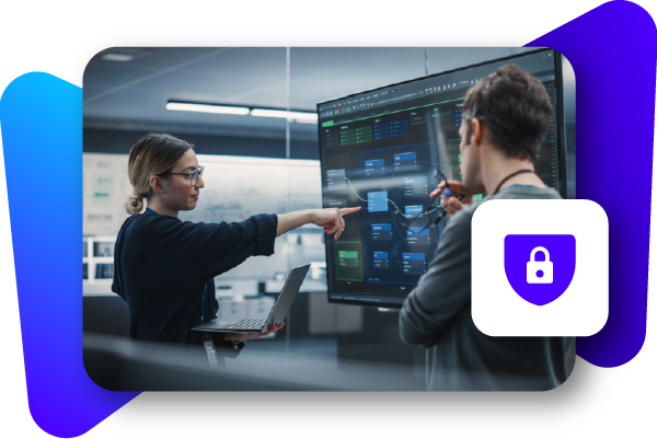 Two professionals analyzing data on large screens in a modern office setting.