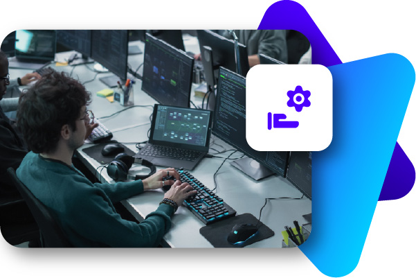 Person using multiple monitors with gaming and streaming equipment in a dark room.