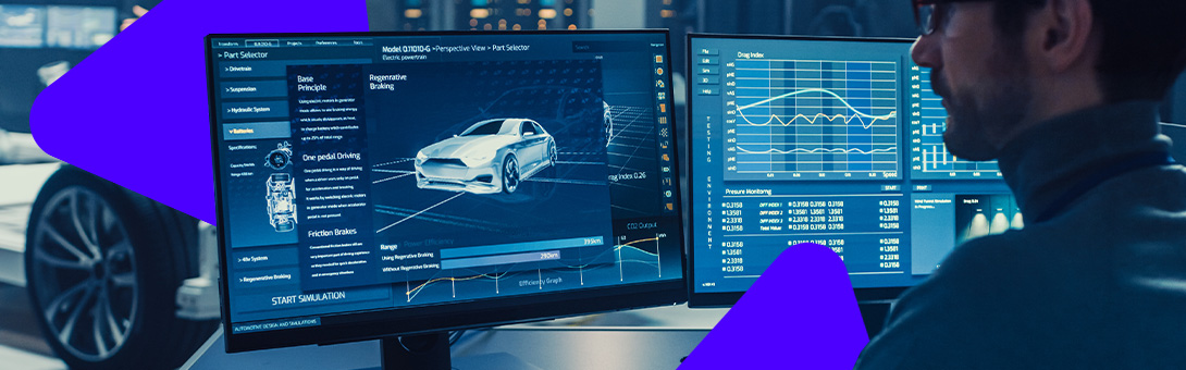 A person sitting at a desk with two monitors displaying car design and technical data, in a dark room with blue lighting.