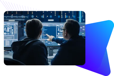 Software developer viewing multiple screens with code.